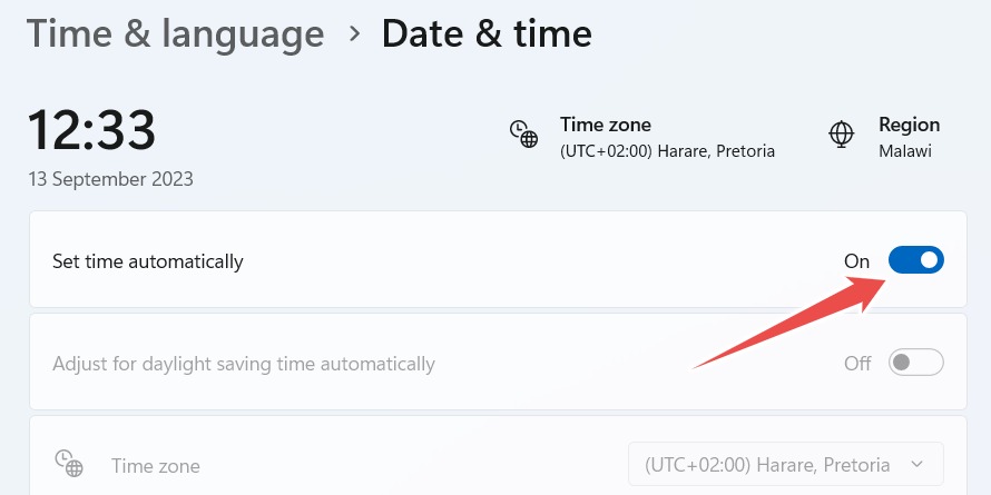 Toggling on the "Set time automatically" option in Windows Settings.