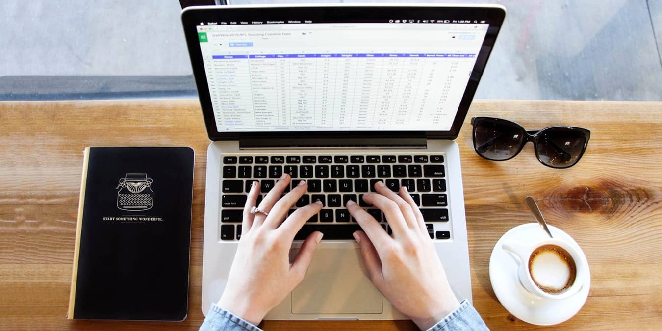 Person editing text on a spreadsheet.