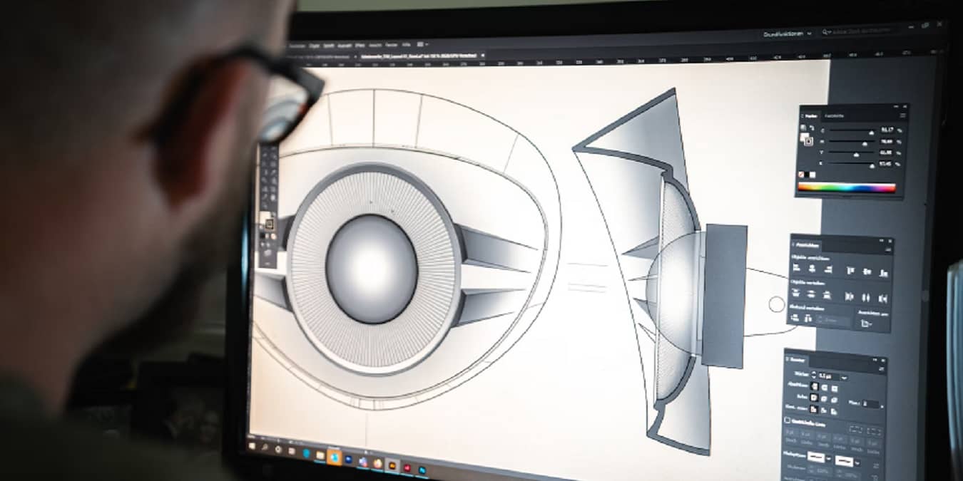 Man looking a CAD design on computer screen.