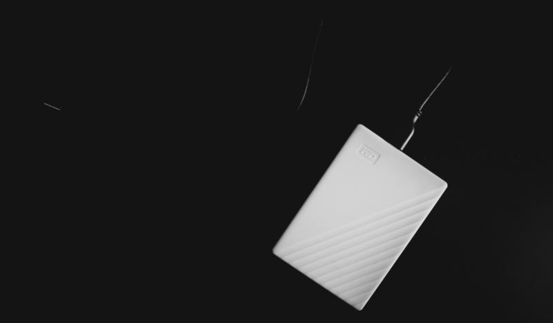 WD My Passport 4TB White external hard drive on a black background
