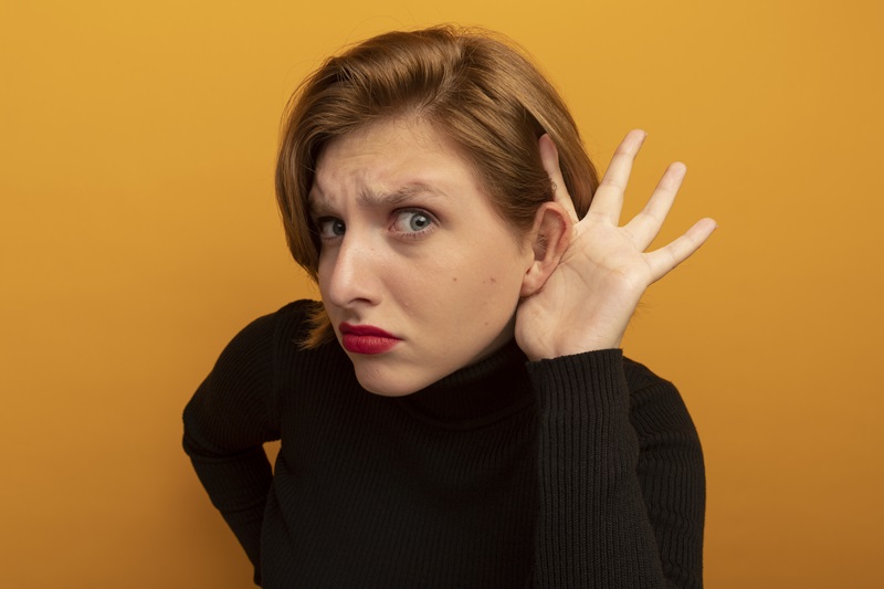 Woman straining herself to hear.