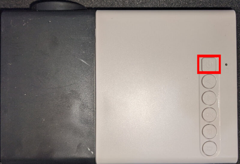 A photograph showing the surface buttons of a simple projector.