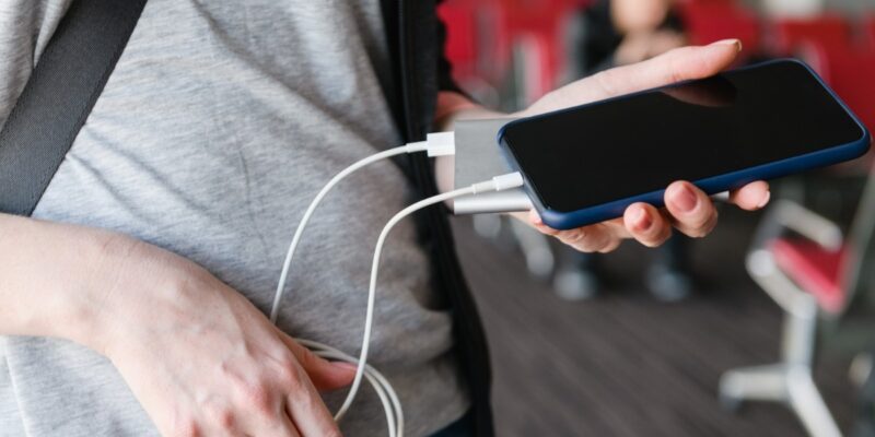 Traveler charging device with power bank before boarding flight