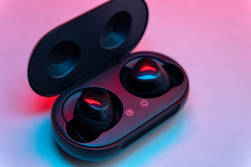 Wireless earbuds in charging case view.
