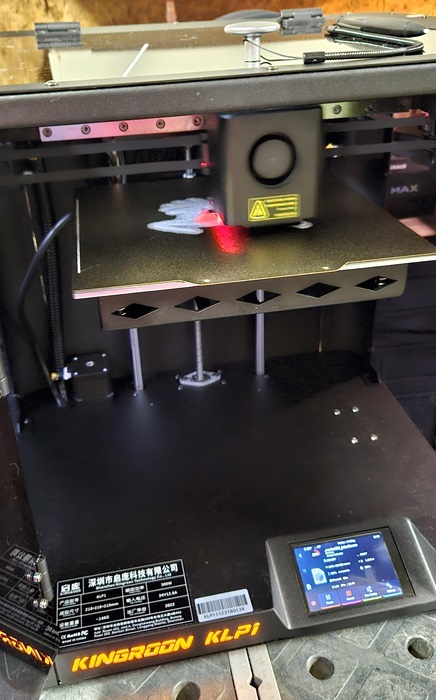 Inside of the 3D printer showing the touchscreen and pen on top.