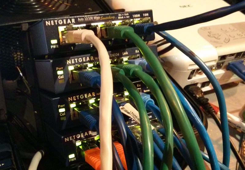 A bunch of total four Netgear Ethernet hubs connecting multiple computers.