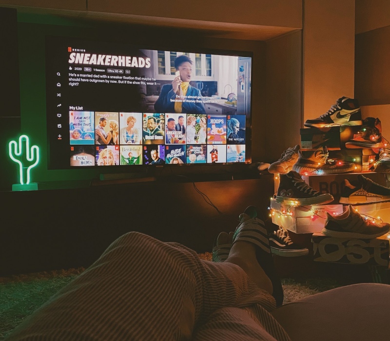 Person watching Netflix on TV
