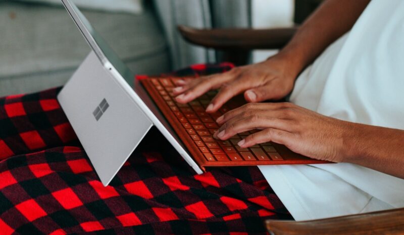 Person working on a hybrid laptop