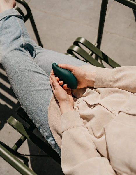 Woman squeezing Moonbird device. 