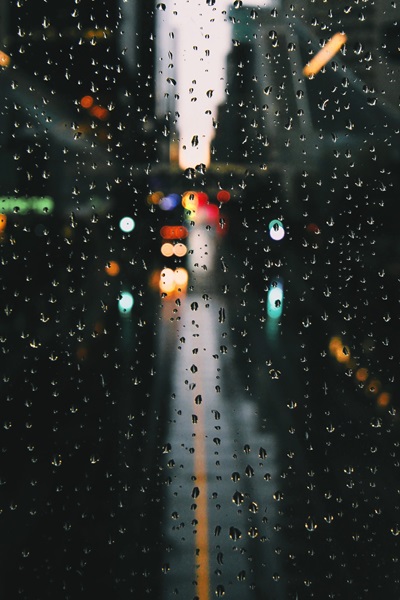 Shot of rain falling on window with bokeh effect applied.