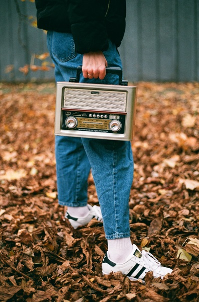 Shot of man carrying radio with bokeh effect applied.