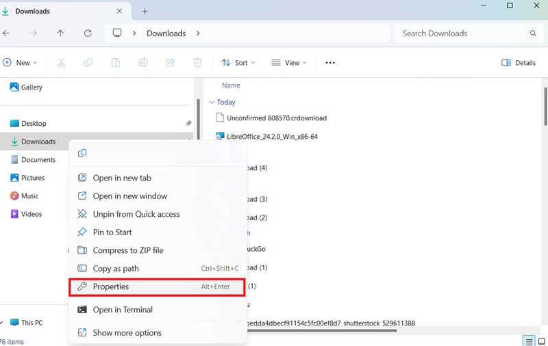 Right-clicking the Downloads folder in Quick Access menu to select its Properties.