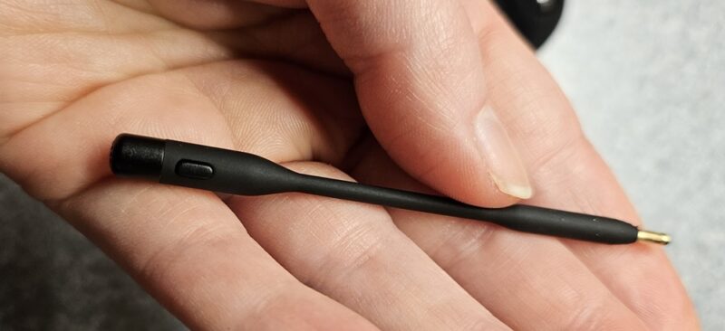 Mic laying in a hand showing the mute button.