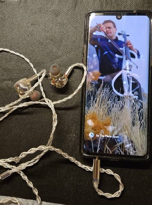 Kiwi Ears attached to phone listening to The Piano Guys