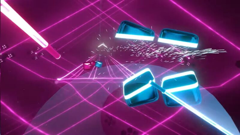 Playing Beat Saber with blue and pink light sabers.