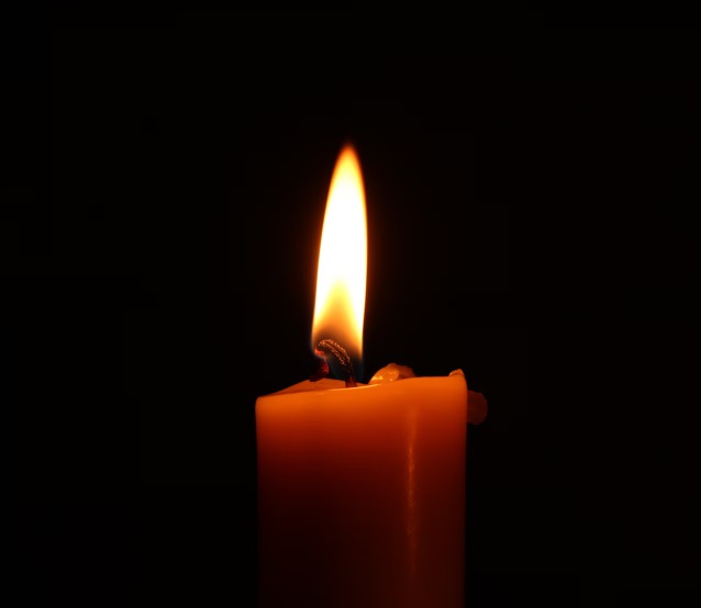 A bright candle with a black background