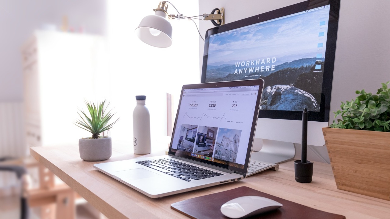 Computer desk setup with a MacBook and iMac