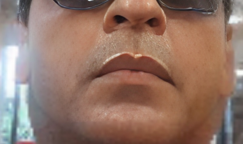 Identifying visual defects by zooming in such as unnatural double chin, face in background, and other prominent signs of fakeness.