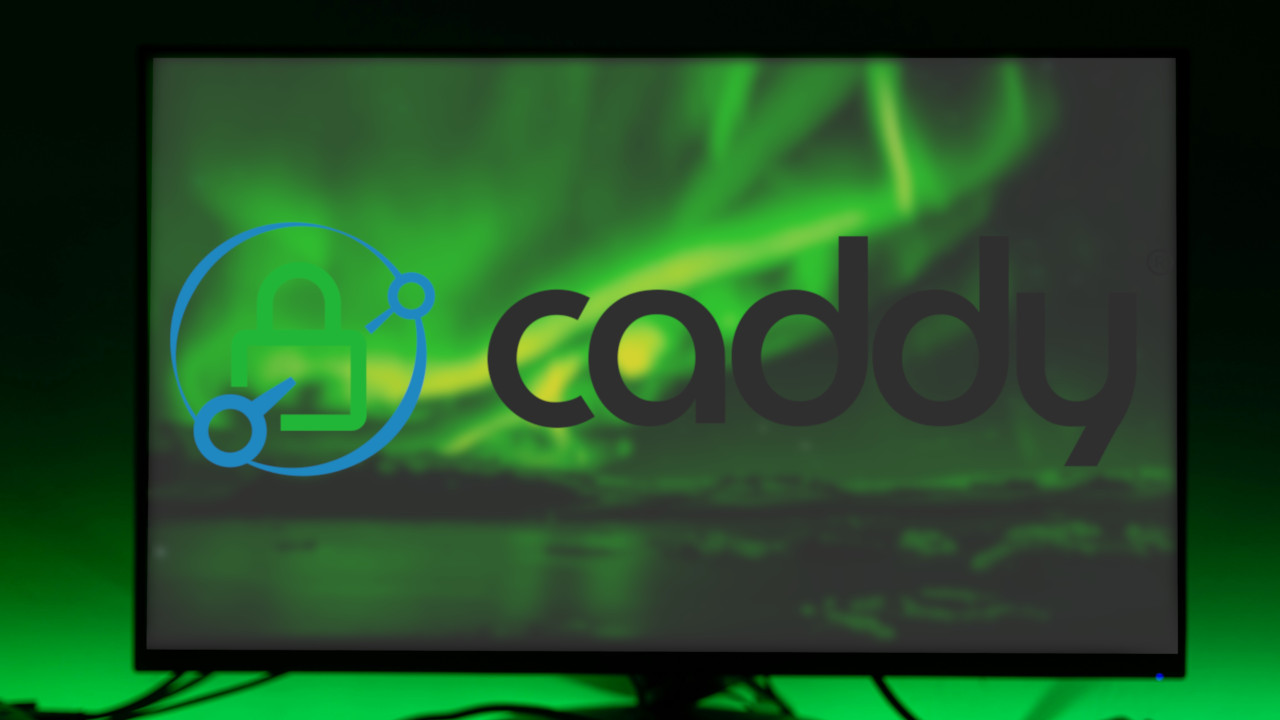 A photograph of a computer monitor on top of a table with a green backlight.