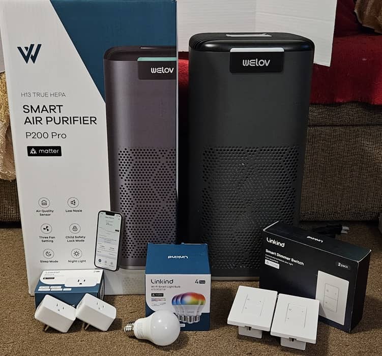AiDot plugs, bulbs, switches, and WELOV air purifier all sitting together.