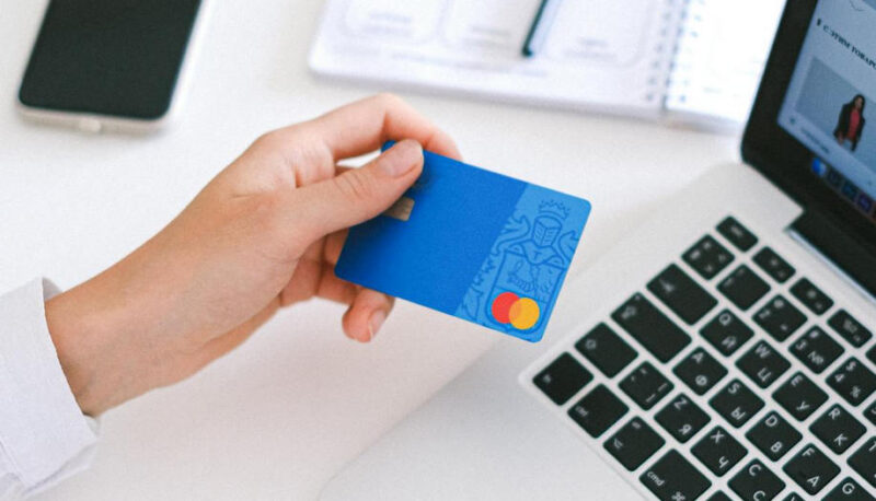 Person Holding A Debit Card