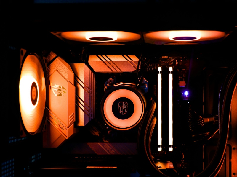 Close up of the inside of a PC showing a liquid cooler, fans, and RAM