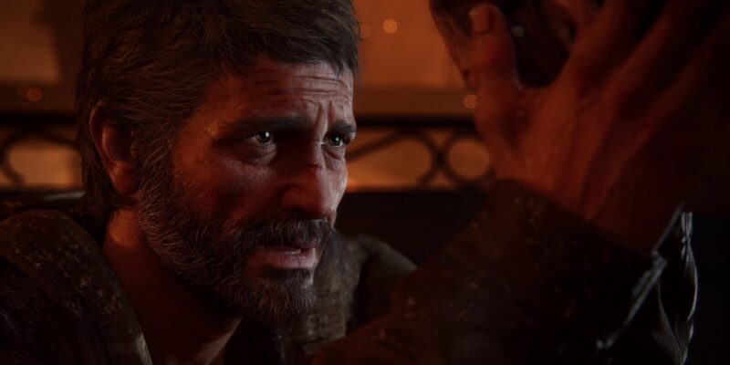Screenshot from The Last Of Us Part 1 showing Joel caressing a person's head