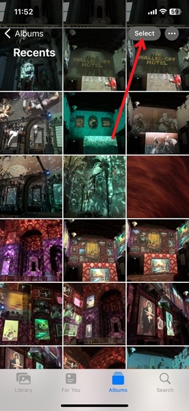 Pressing "Select" button to pick images for sharing in Photos app on iPhone.
