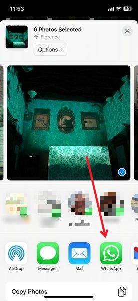 Opting for WhatsApp when it comes to sharing images via Photos app on iPhone.