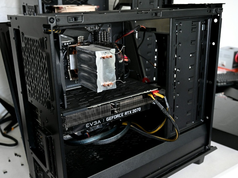 A black gaming PC with the inside showing a graphics card and CPU cooler