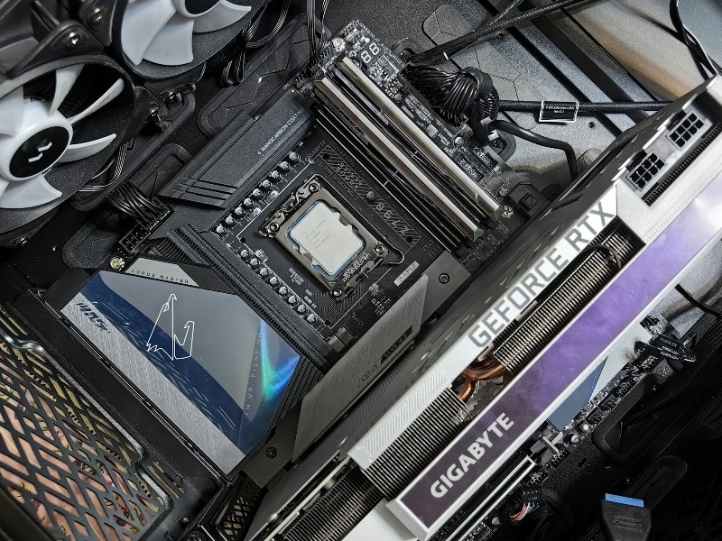 Close-up of the inside of a gaming PC showing the graphics card, motherboard, CPU, and fans
