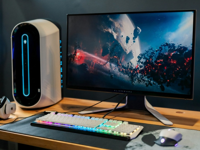 A gaming PC setup on a desk with an Alienware PC and monitor