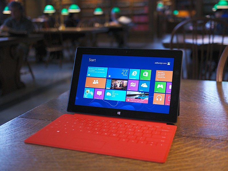 Microsoft Surface RT laptop on a brown desk with the background blurred