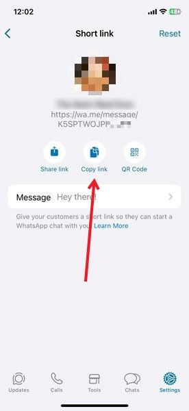 Tapping on "Copy link" option in WhatsApp on iPhone.