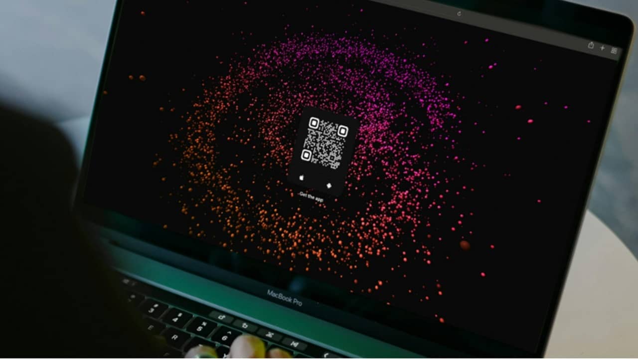 Laptop with a QR code on it.