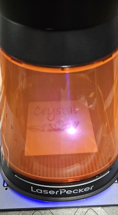 Watching the laser engraver in progress.