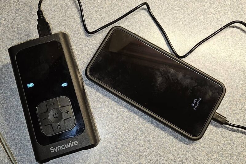 Charging a phone with the tire inflator.