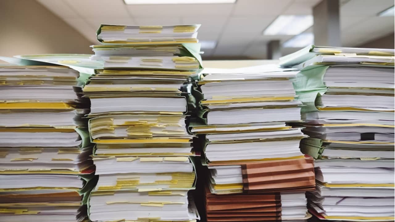 Large stacks of files on a counter.
