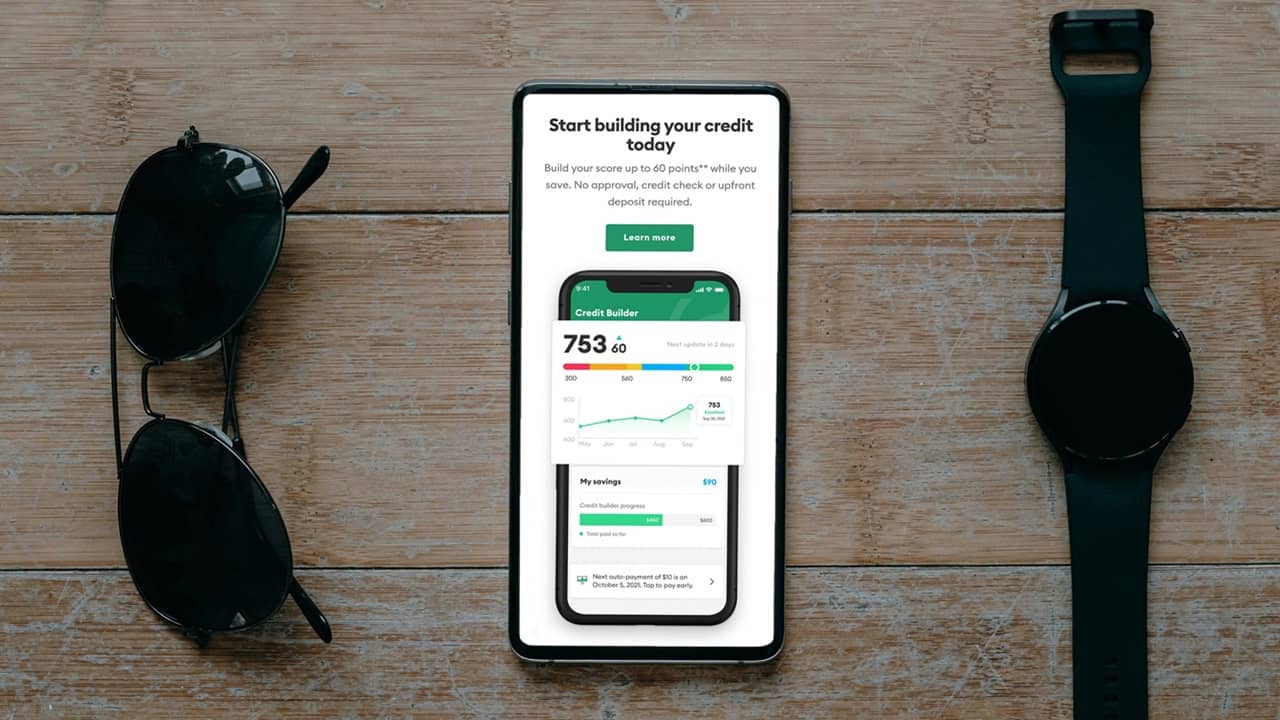 Sample of a credit score app with sunglasses and watch on either side.