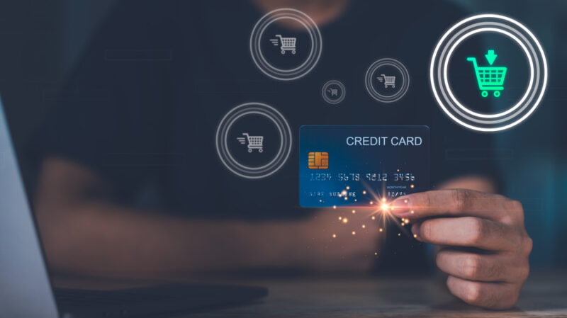 man showing credit card with shopping cart icons