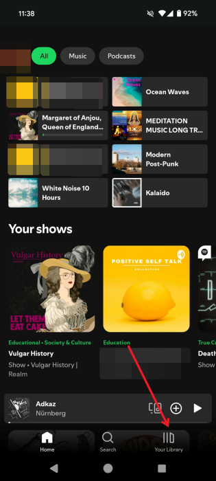 Tapping on "Your Library" tab in the Spotify app. 