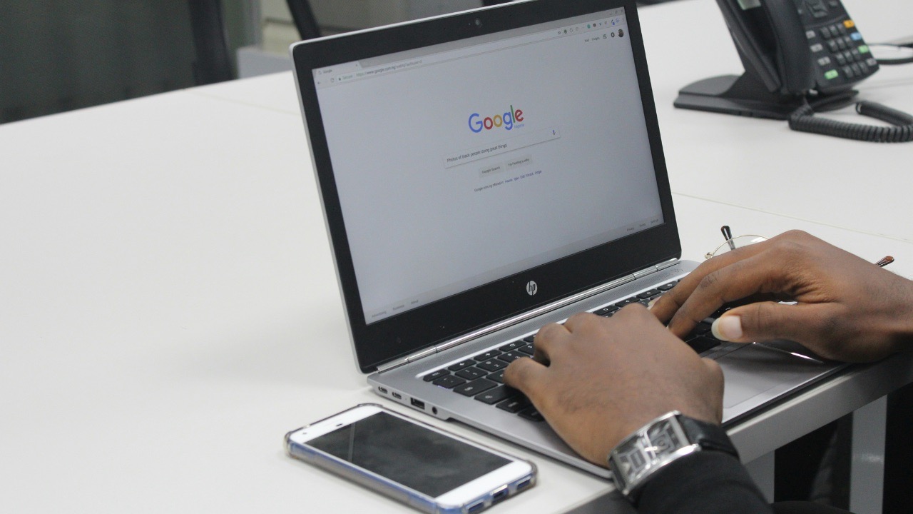 A man typing on a computer in Google Chrome