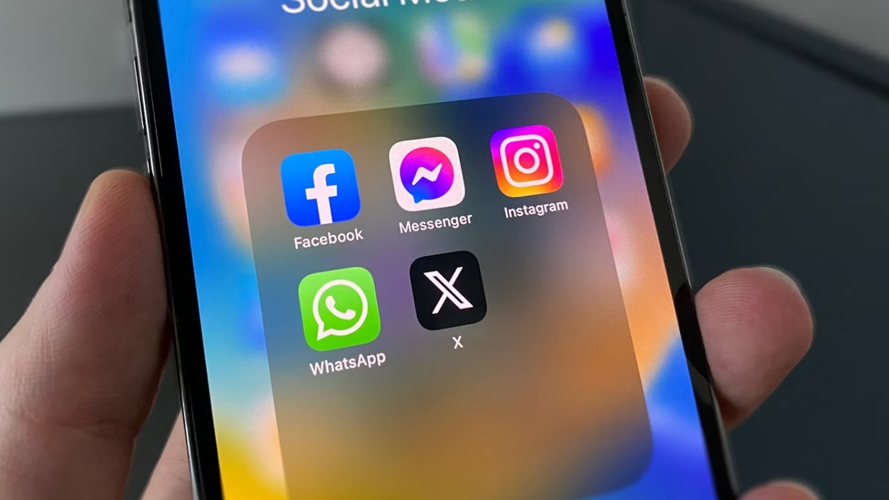 Phone with social media apps, including WhatsApp.
