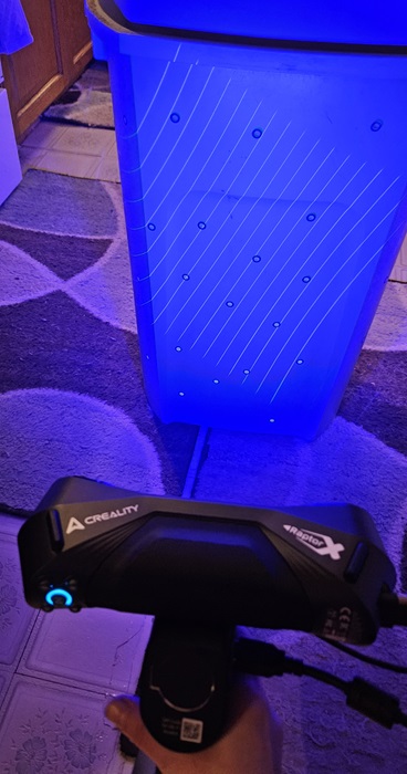 Scanning a trash can with blue lights.