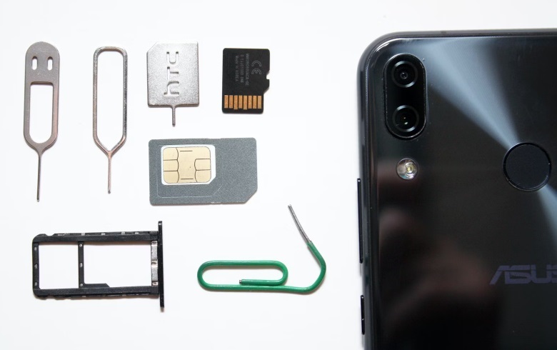 SIM card, SD card, SIM keys, and a phone.