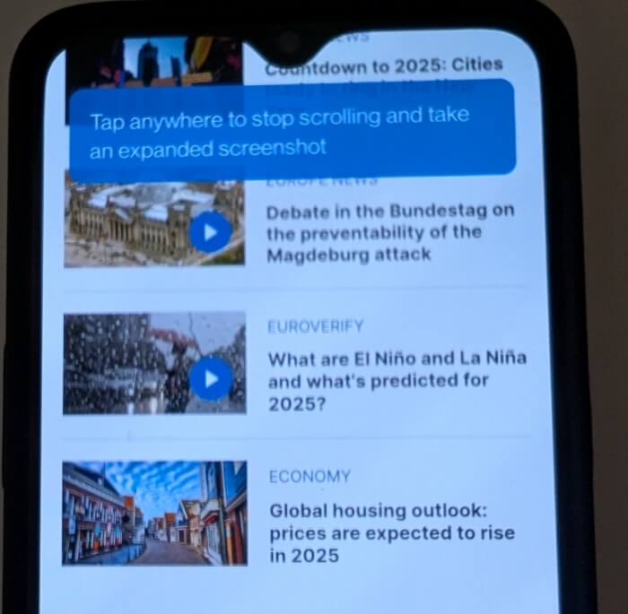 Tapping anywhere on screen to stop scrolling screenshot on OnePlus phone.