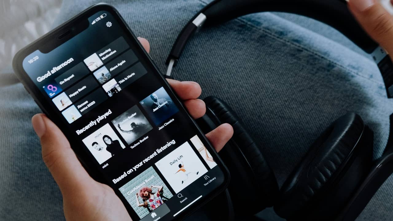 Person streaming music on their phone.