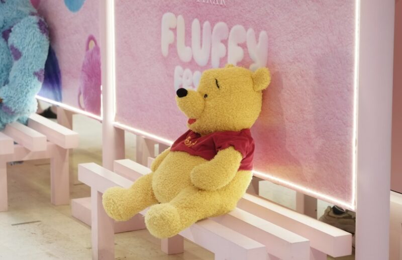 Winnie the Pooh plush on a bench
