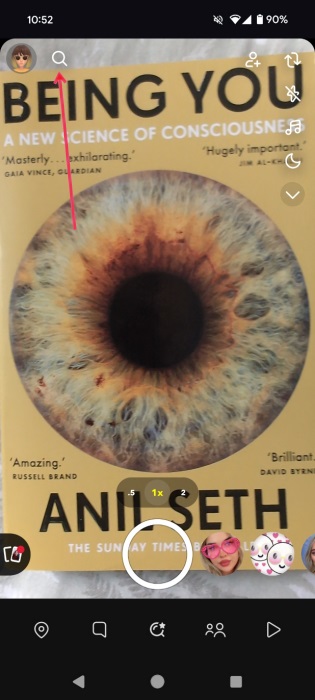 Pressing on magnifying glass icon in Snapchat app. 