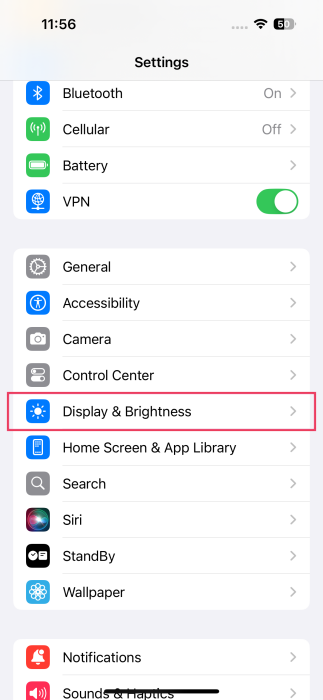 Tapping on "Display & Brightness" option in iPhone Settings. 